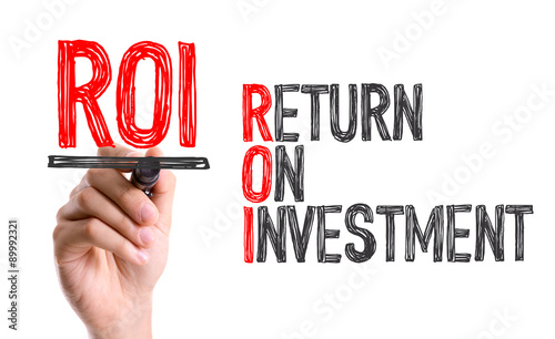Hand with marker writing the word ROI - Return on Investment photo