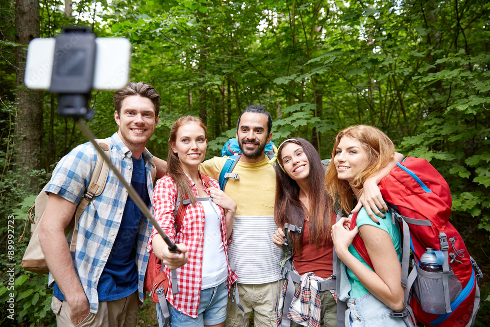 friends with backpack taking selfie by smartphone friends with backpack taking selfie by smartphone