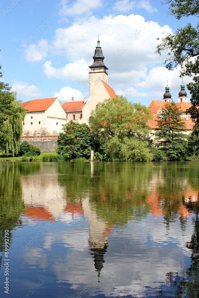 fairy tale castle and its mirror image on the surface of the pond, Telc, Moravia, Czech republic