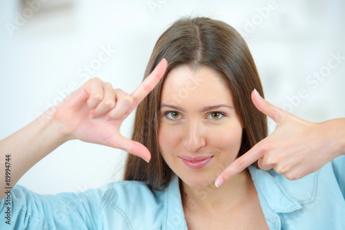 Girl framing face with hands