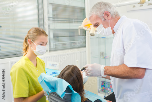 Busy dentist with a patient