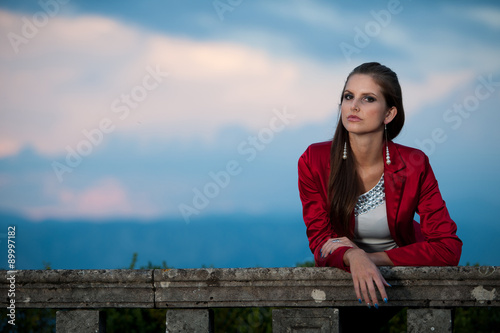 Blog style beautiful brunette woman in fashionable dress posing