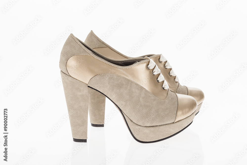 heeled shoes golden with white laces for women on white background heeled shoes golden with white laces for women on white background