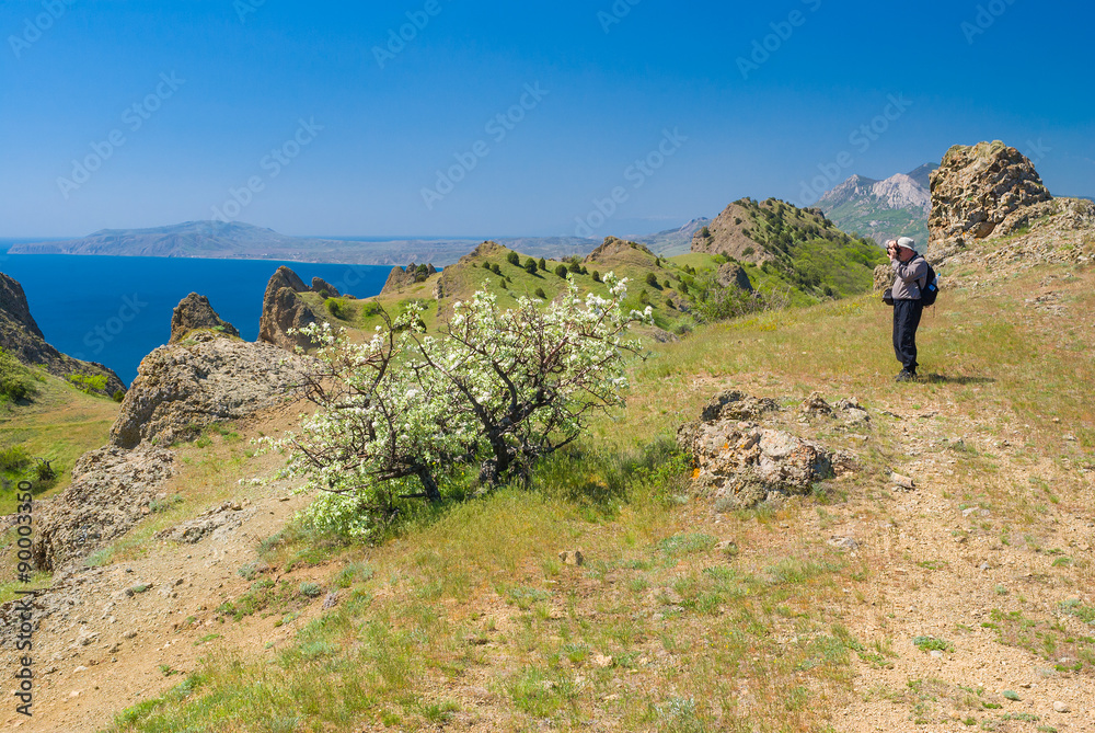 Lonely hiker photographs on a Kara-dag natural reserve, Eastern Crimea