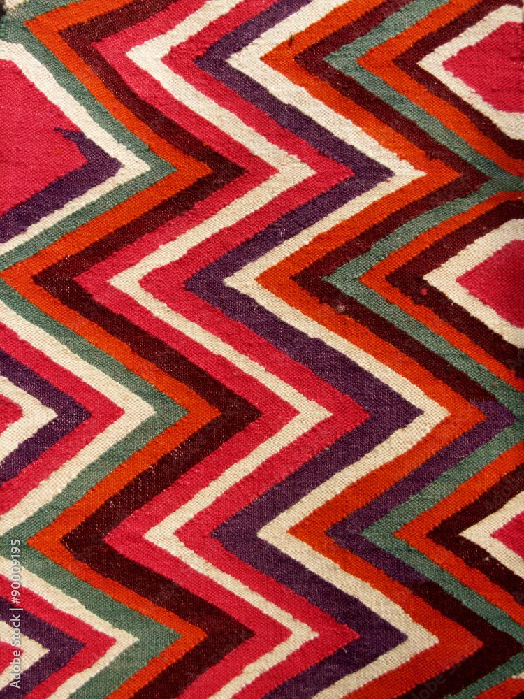 Close up of a hanged colourful handmade traditional wool rug Close up of a hanged colourful handmade traditional wool rug