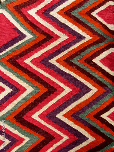 Close up of a hanged colourful handmade traditional wool rug