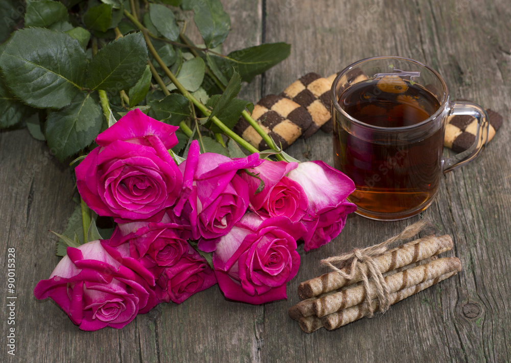 festive still life from flowers, cookies and tea on a wooden table festive still life from flowers, cookies and tea on a wooden table
