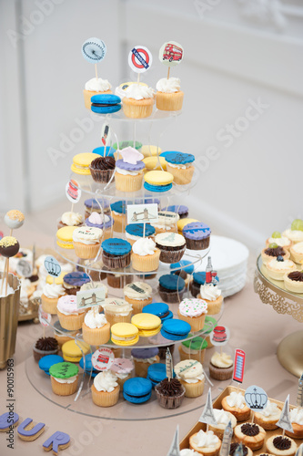 Wedding decoration with pastel colored cupcakes  meringues  muffins and macarons