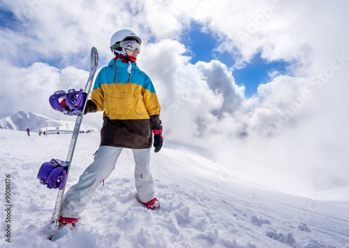 Snowboarder woman in mountains