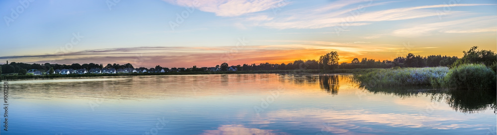 Naklejka premium sunset in Zinnowitz with reflection of the backwater