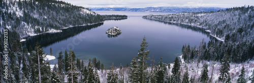 This is Emerald Bay after a winter snow storm. There is snow covering the ground surrounding the bay. #90022133