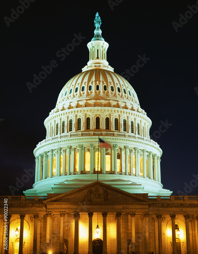 This is the U.S. Capitol at dusk. The lights are on in the rotunda. We see it against a clear night sky.