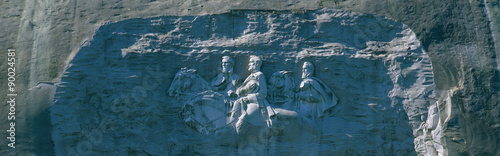 This is the Confederate Civil War Memorial Carving at Stone Mountain Park showing Jefferson, Davis, Robert E. Lee, and Stonewall Jackson. It is carved into granite rock. photo