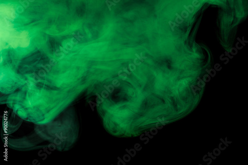 Abstract green smoke hookah on a black background.