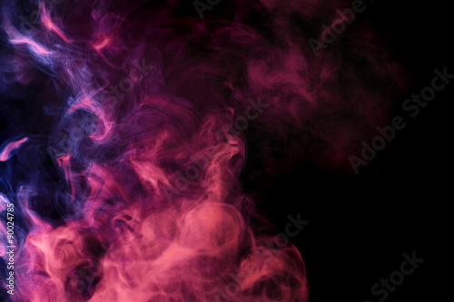 Abstract colored smoke hookah on a black background.