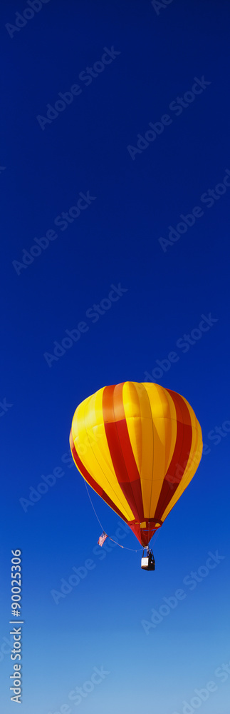 Fototapeta premium This is the 25th Annual Albuquerque International Balloon Fiesta. It shows a red and yellow balloon that is part of the mass ascension of colorful balloons.