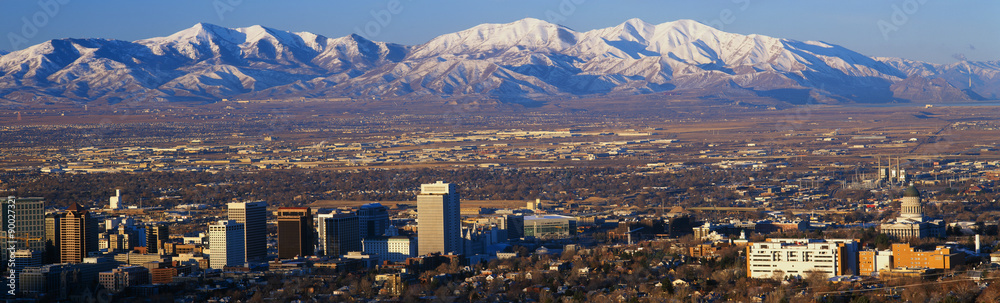 This is the State Capitol with the Great Salt Lake and snow capped Wasatch Mountains in morning light. It will be the winter Olympic city for the year 2002.