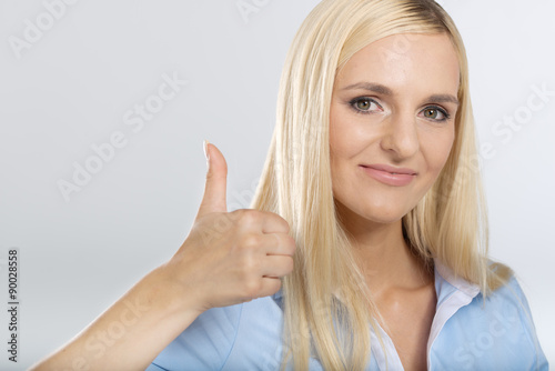 young woman showing thumb up sign