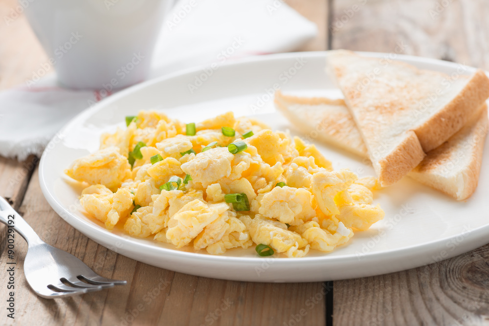 breakfast with scrambled egg, toasts and coffee. breakfast with scrambled egg, toasts and coffee.
