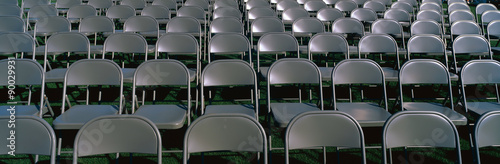Photography These are empty, grey folding chairs awaiting the crowd to attend the U