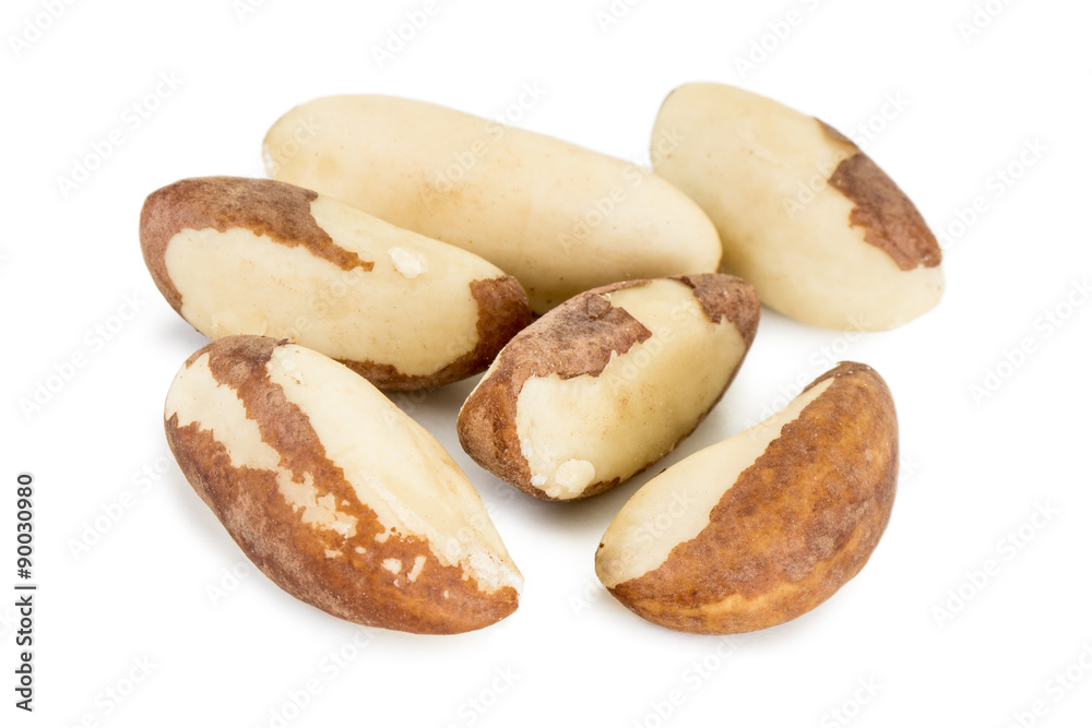 Close-up of several brazil nuts isolated on white background.