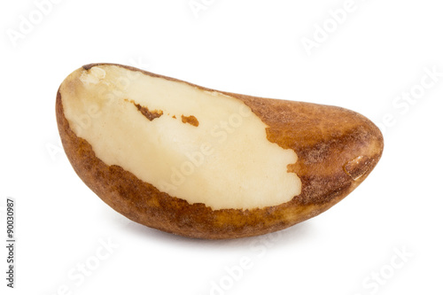 Close-up of a single brazil nut with a shadow, isolated on white background.