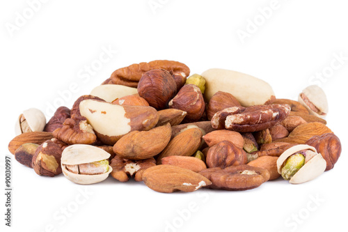 Close-up of mixture of several different peanuts, isolated on white background.