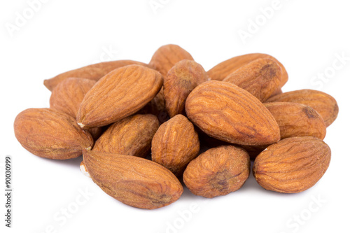 Close-up of a heap of almond seeds isolated on white background.