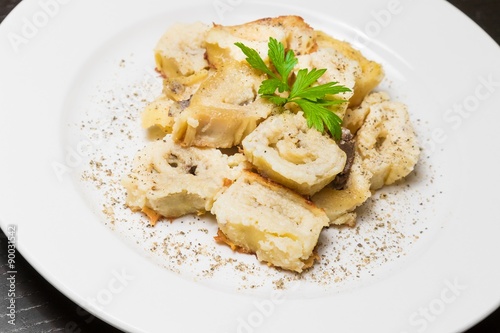 detail of dish of italian swivels pasta with porcini mushrooms and sauce bechamel with pepper