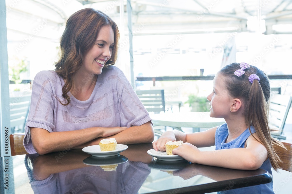 Mother and daughter enjoying cakes