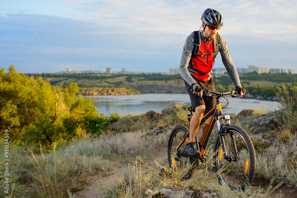 Cyclist Riding the Bike on the Beautiful Spring Mountain Trail Cyclist Riding the Bike on the Beautiful Spring Mountain Trail