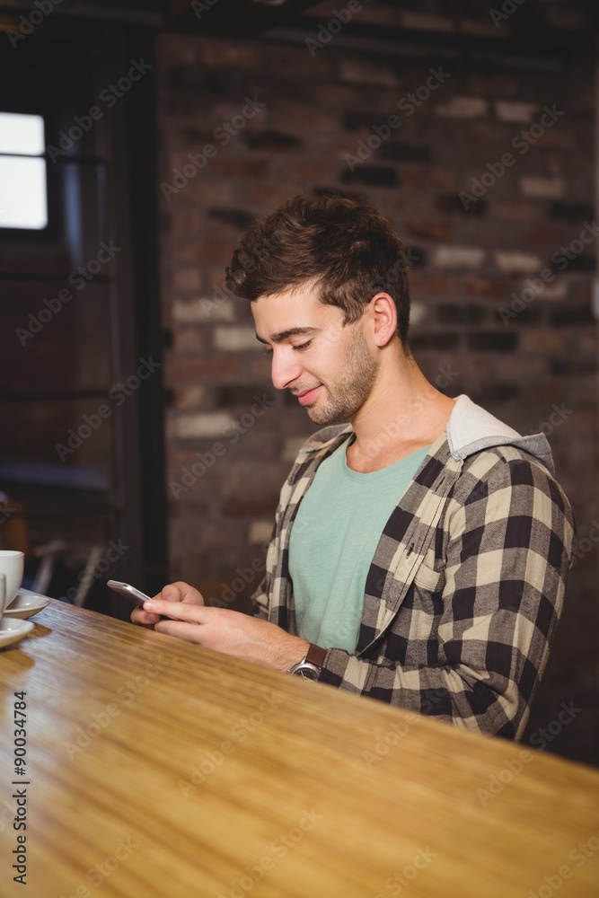 Smiling hipster sitting and texting