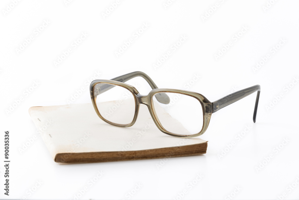 old book with glasses on white background old book with glasses on white background