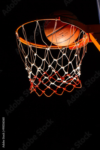 Basketball hoop on black background with light effect © torsak