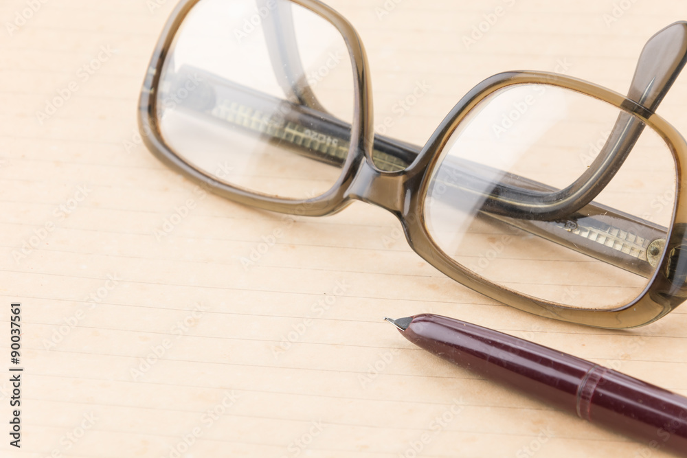 old paper with pen and glasses on white background old paper with pen and glasses on white background