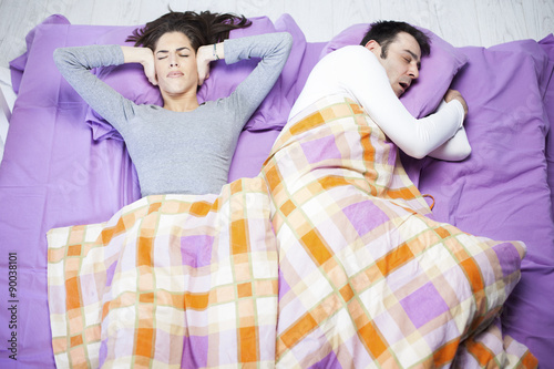 Snoring man. Couple in bed, man snoring and woman can not sleep, photo