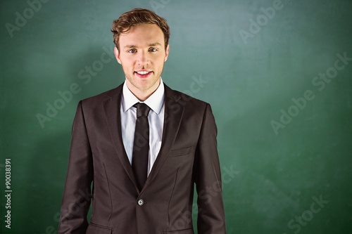Composite image of young businessman smiling at camera © vectorfusionart
