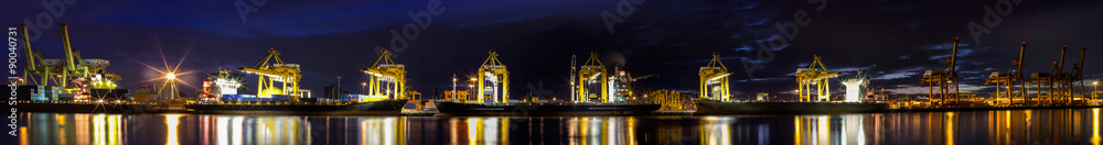 Obraz premium Container Cargo freight ship with working crane loading bridge i