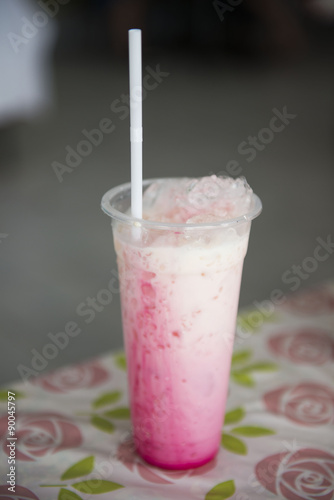 Thai pink tea with milk in plastic glass