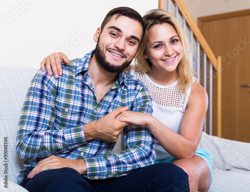  guy and cheerful pretty girl smiling indoors