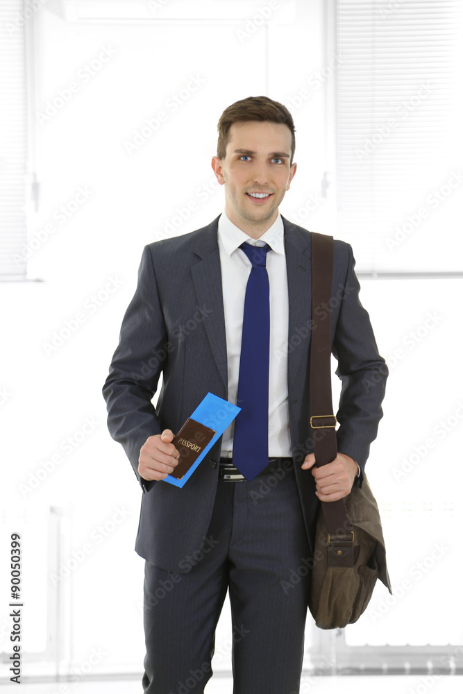 Man holding suitcase on light background Man holding suitcase on light background