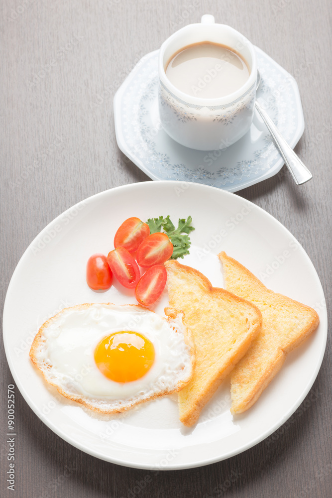 breakfast with fried eggs and toasts on wooden table breakfast with fried eggs and toasts on wooden table