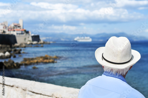 old man looking at the sea in Antibes, France, filtered