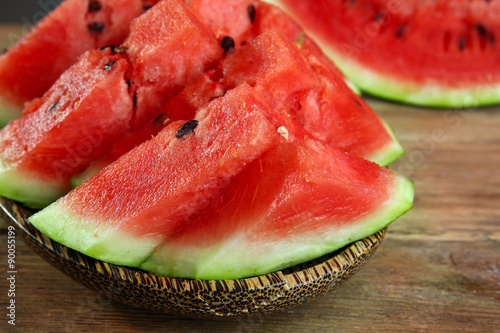 Slices of ripe watermelon on wooden table close up