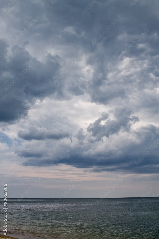 Vertical storm seascape with cloudy sky