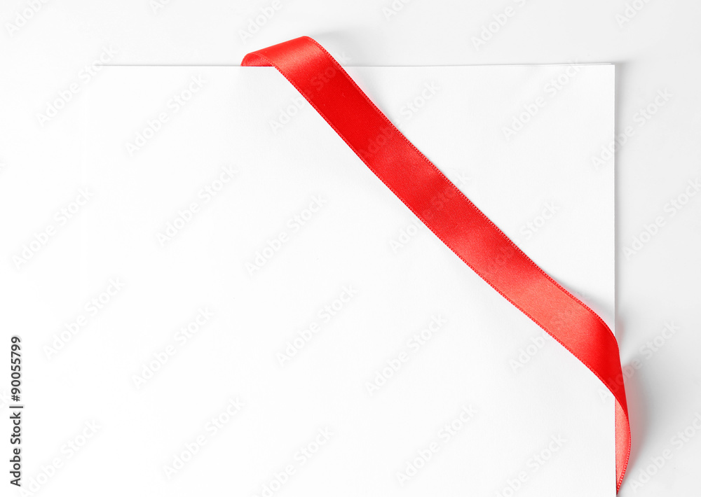 Shiny red ribbon with card close up Shiny red ribbon with card close up
