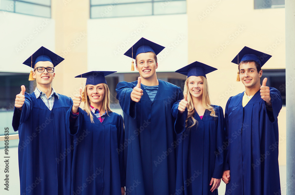 group of smiling students in mortarboards group of smiling students in mortarboards