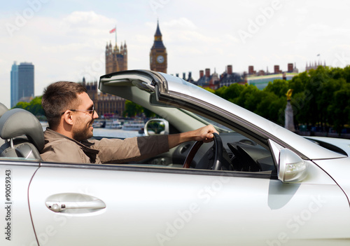 Photography happy man near cabriolet car over london city