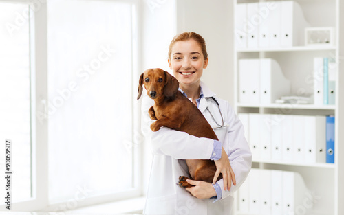 happy doctor with dog at vet clinic photo