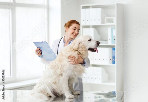 happy doctor with retriever dog at vet clinic